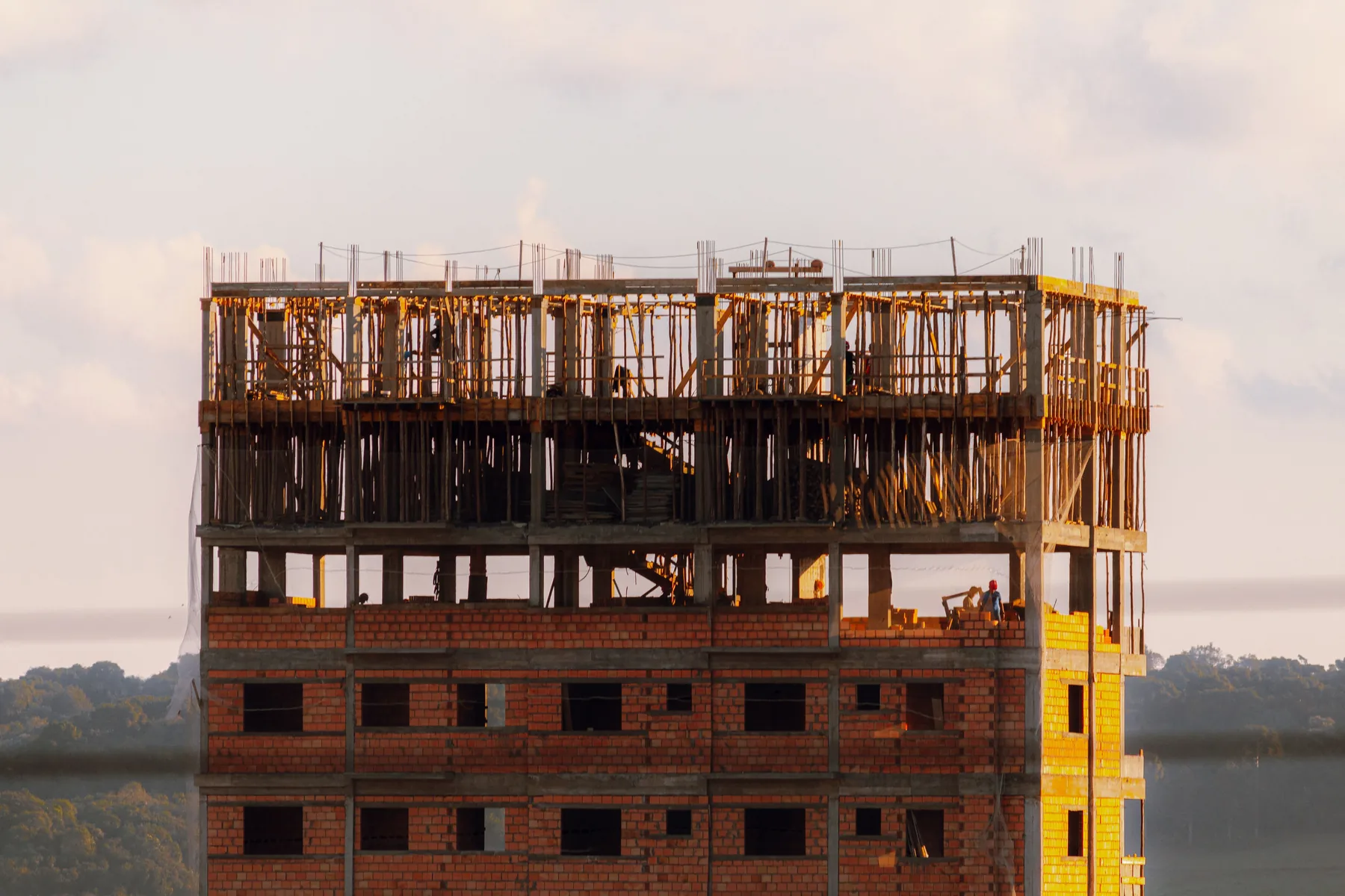 Decorative view of a multi-storey brick building under construction