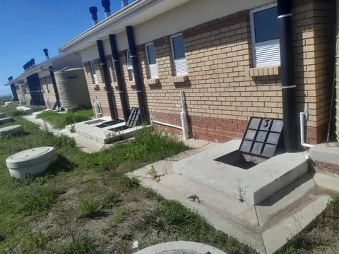 Brick building exterior with completed access and drainage works