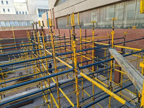 Masonry construction with scaffold access and workers on site