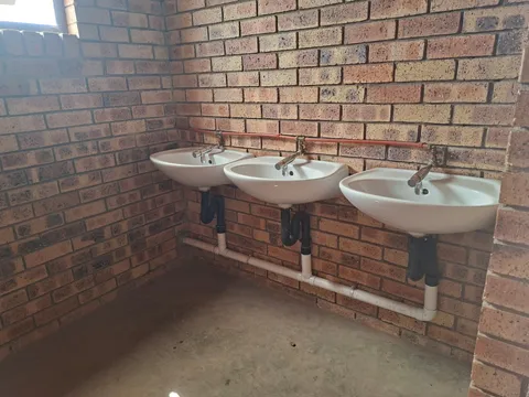 Installed wash basins and sanitary fixtures in a brick interior