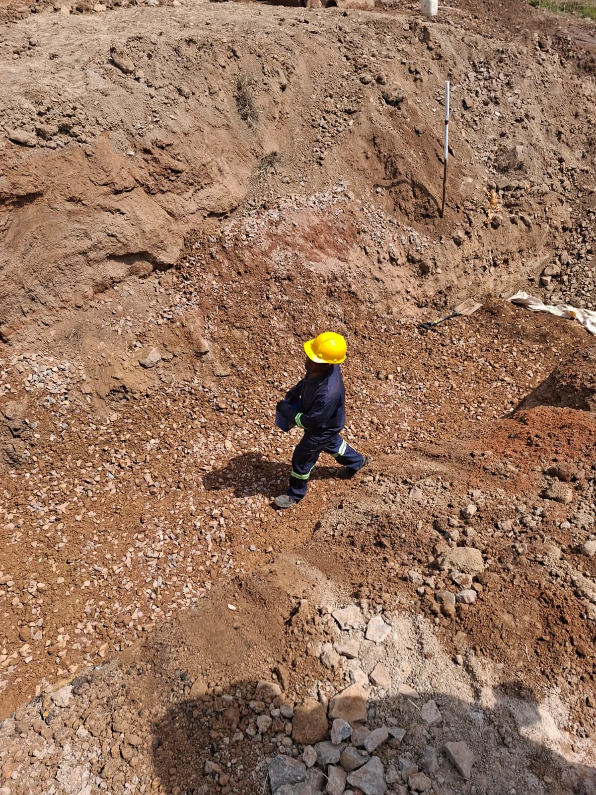 Workers preparing deep drainage trenches and pipe routes