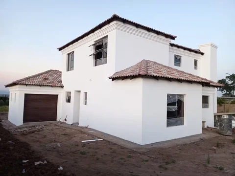 Two-storey white residential building with tiled roof
